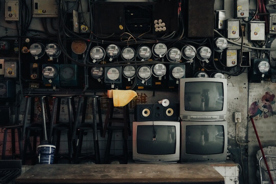 Vintage television control room with rows of monitors and analogue switches